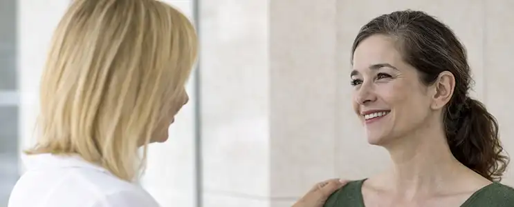 Patient receiving reassurance from a radiologist at Genesis while discussing breast screening and supportive care options